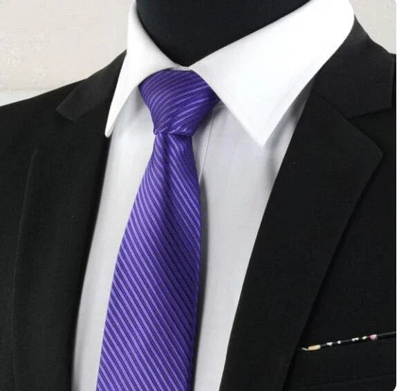 Black suit jacket with white dress shirt and purple striped tie on mannequin