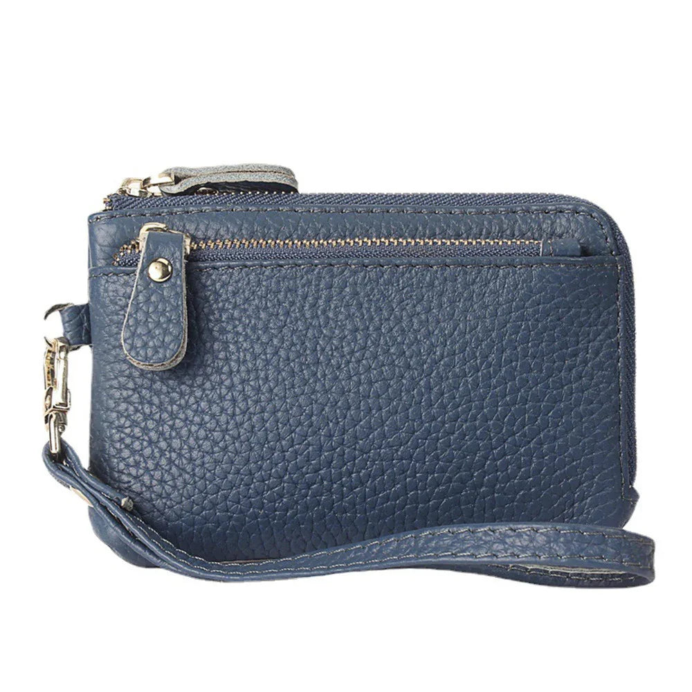 blue textured leather wristlet wallet with zippered compartments and wrist strap