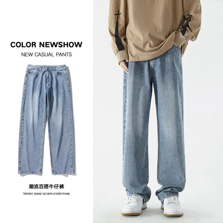 Light blue casual denim jeans for men with loose fit styling and white sneakers