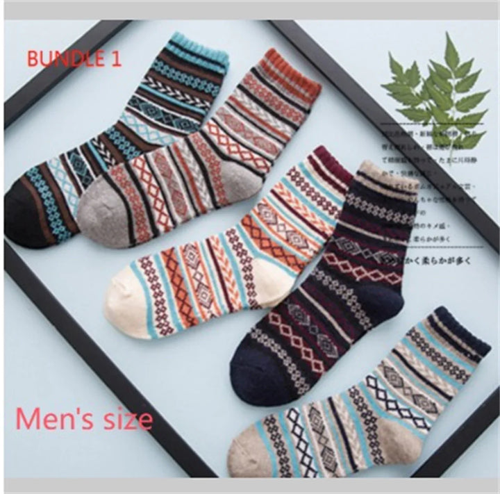 Bundle of men's size colorful patterned warm socks with geometric designs on a light background