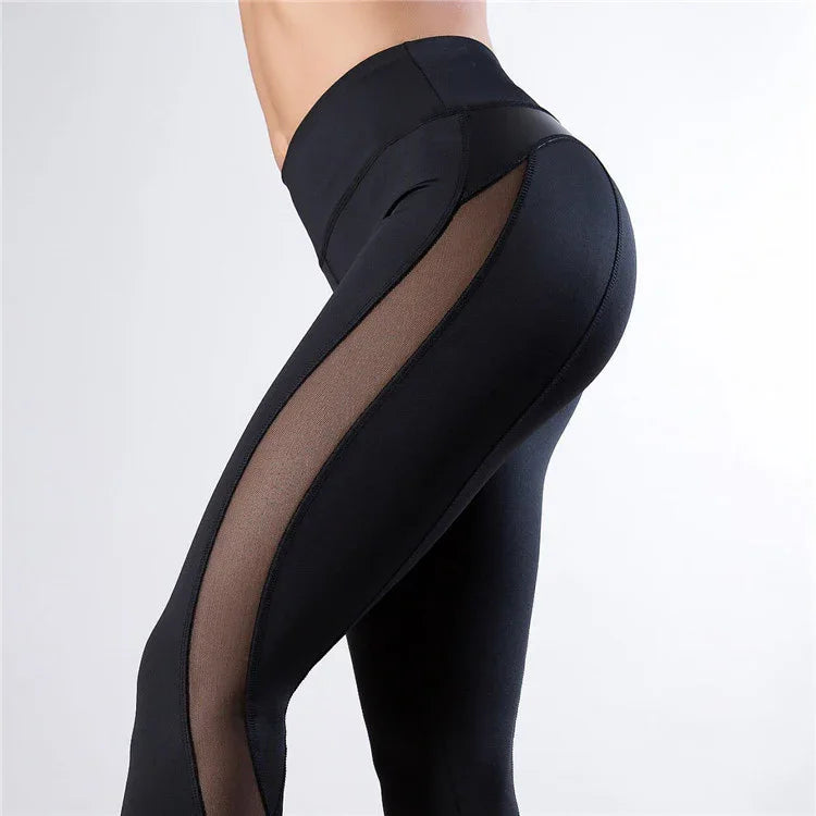 Black high-waisted leggings with sheer mesh side panels on a model, fitness apparel