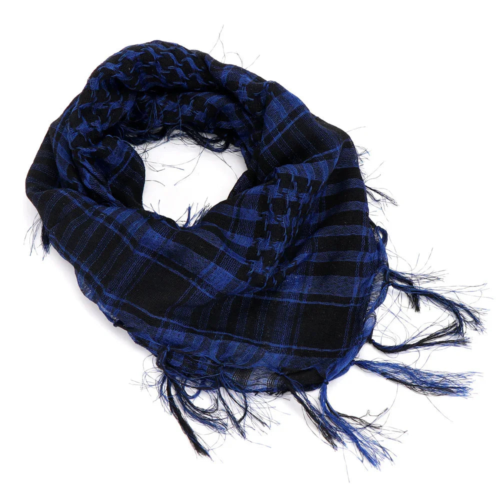 Blue and black checkered fringed scarf twisted on white background
