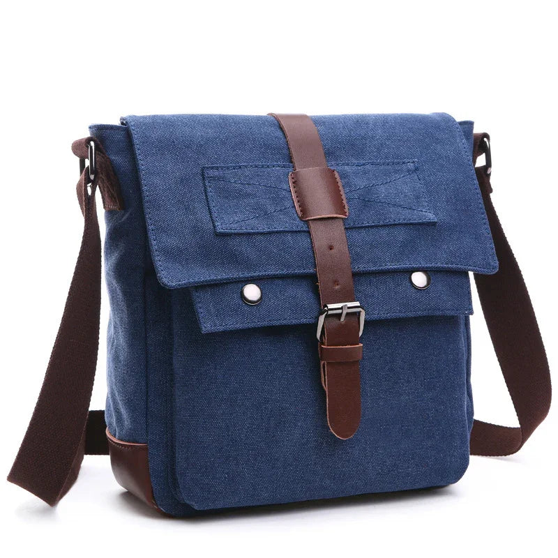Blue canvas messenger bag with brown leather strap and adjustable shoulder strap