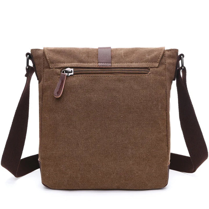 Brown canvas crossbody messenger bag with front zipper pocket and adjustable strap