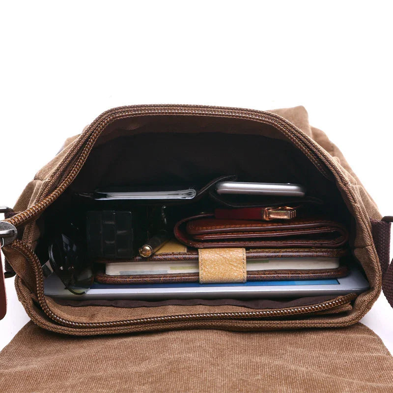 Open brown canvas bag filled with organized items including a wallet, notepad, smartphone, and pen