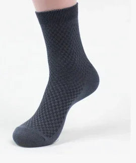 Black textured dress sock displayed on a foot mannequin against white background