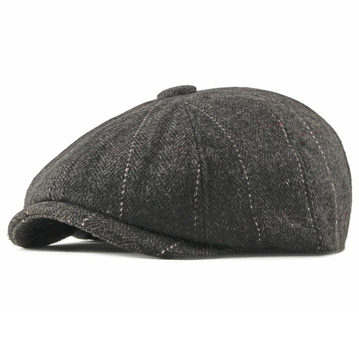 Dark gray wool newsboy cap with subtle pink stitching on white background