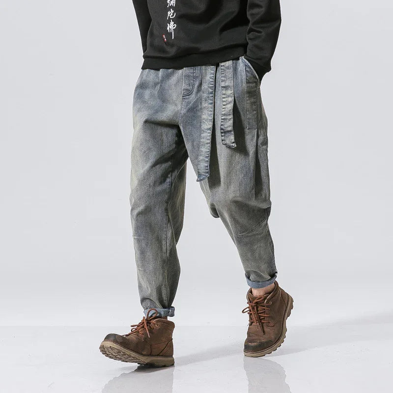 mens loose fit faded gray denim pants with belt and brown lace-up boots