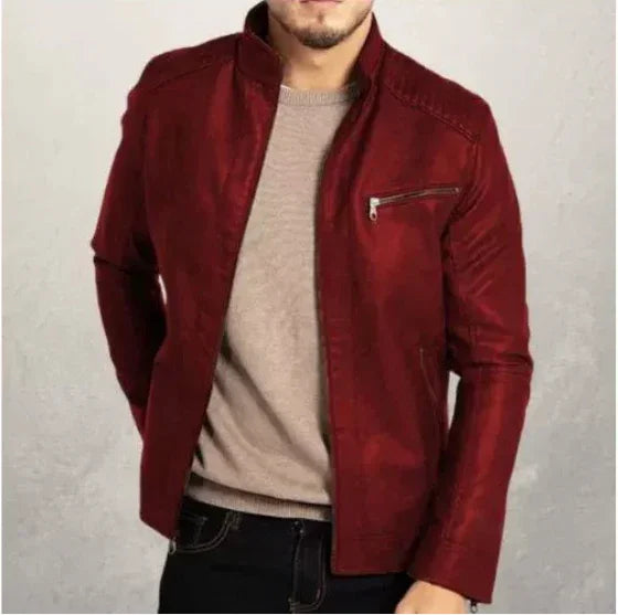 man wearing stylish red leather jacket over beige sweater and dark jeans on neutral background