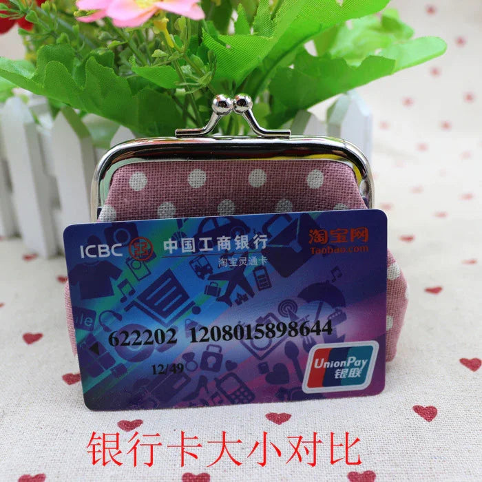 ICBC UnionPay bank card held in front of a pink polka dot coin purse with green plant background on heart-patterned fabric