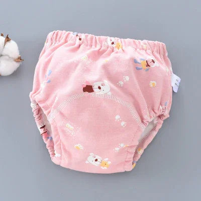 Pink baby training pants with cute bear and paw print design on soft fabric