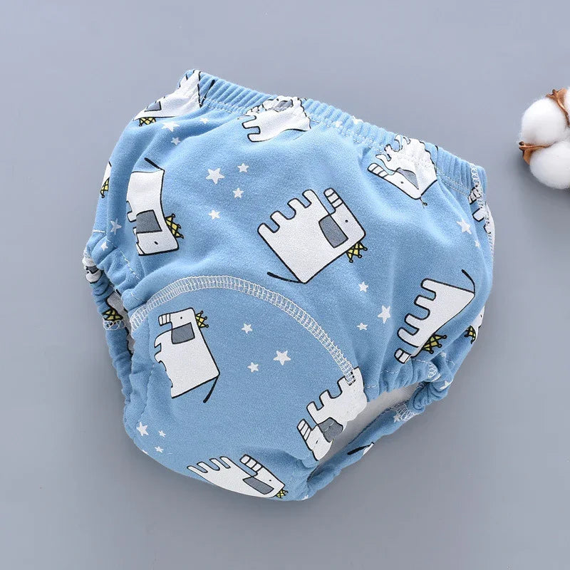 Blue baby training pants with white cartoon elephants and star patterns on a gray background