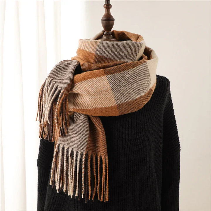 Plaid brown and beige fringed scarf wrapped on mannequin with black ribbed sweater