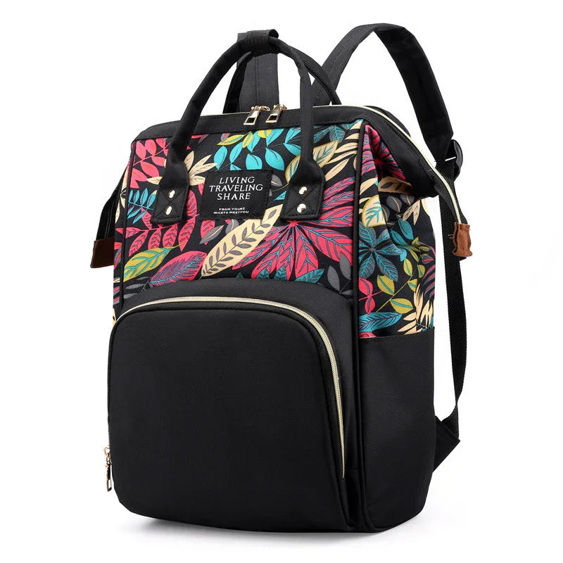 Black backpack with colorful tropical leaf print, front zipper pocket, and dual handles