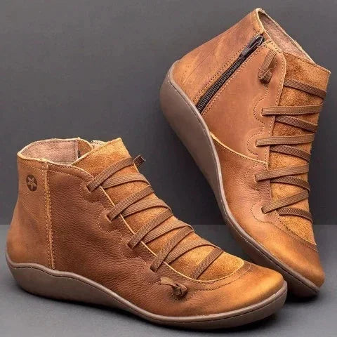 brown leather ankle boots with side zipper and lace-up design on gray background