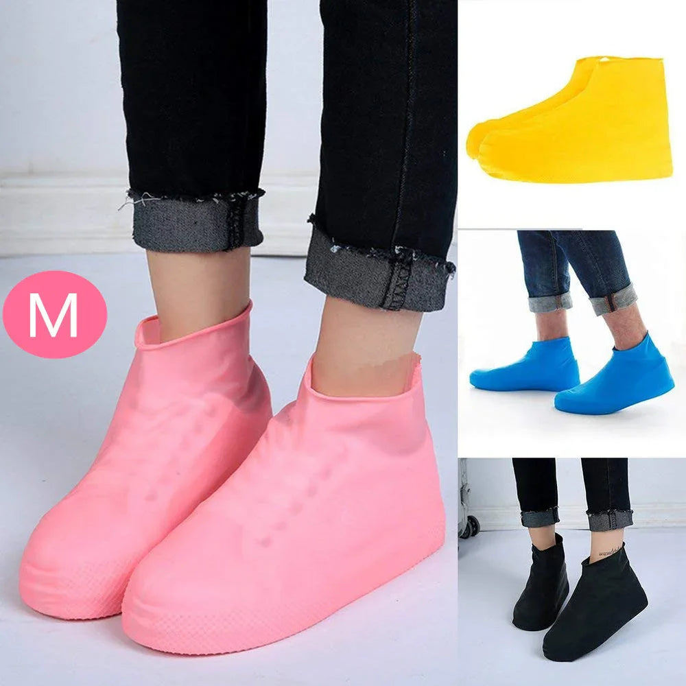 Waterproof silicone shoe covers in pink, yellow, blue, and black colors worn over casual shoes indoors