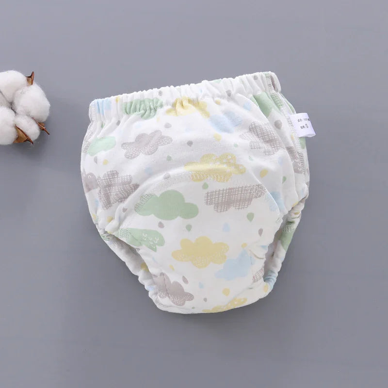 Soft cotton baby training pants with pastel cloud print on gray background