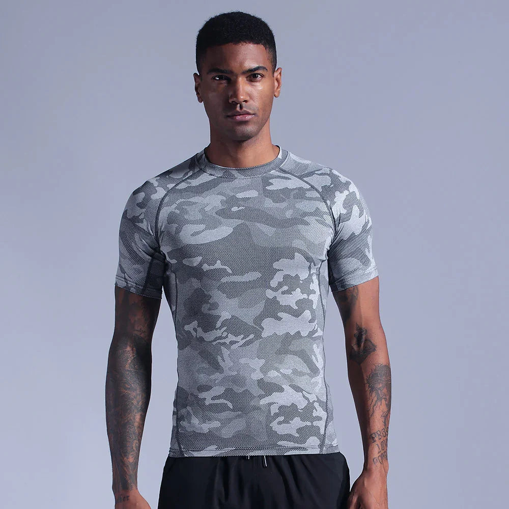 Fit man wearing gray camo short-sleeve athletic shirt against light gray background