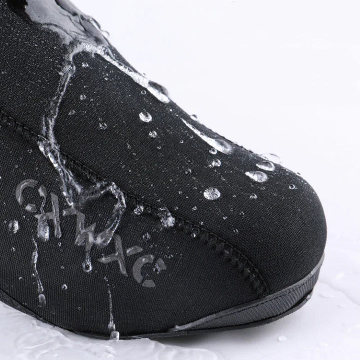 Close-up of black waterproof fabric shoe with water droplets and flowing water