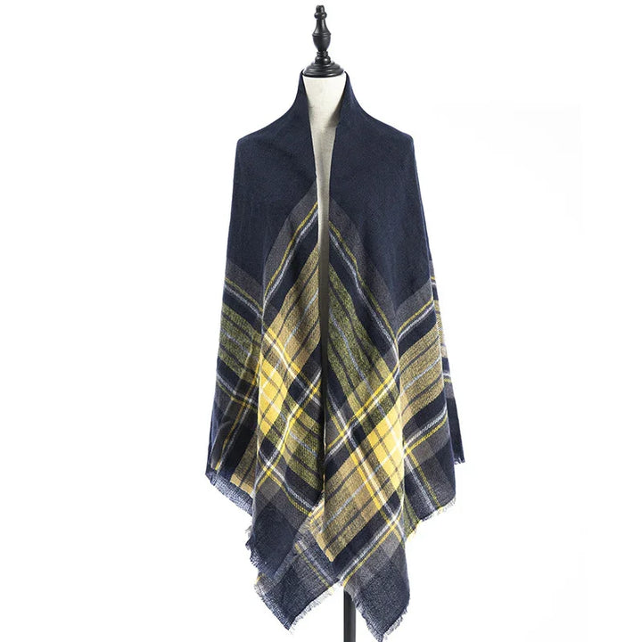 Navy blue and yellow plaid shawl wrap displayed on dress form with fringe edges