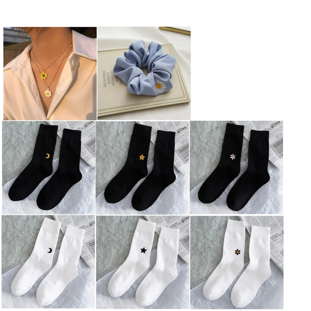 Blue scrunchie with daisy embroidery, layered daisy necklaces, and black and white socks with moon, star, and flower designs