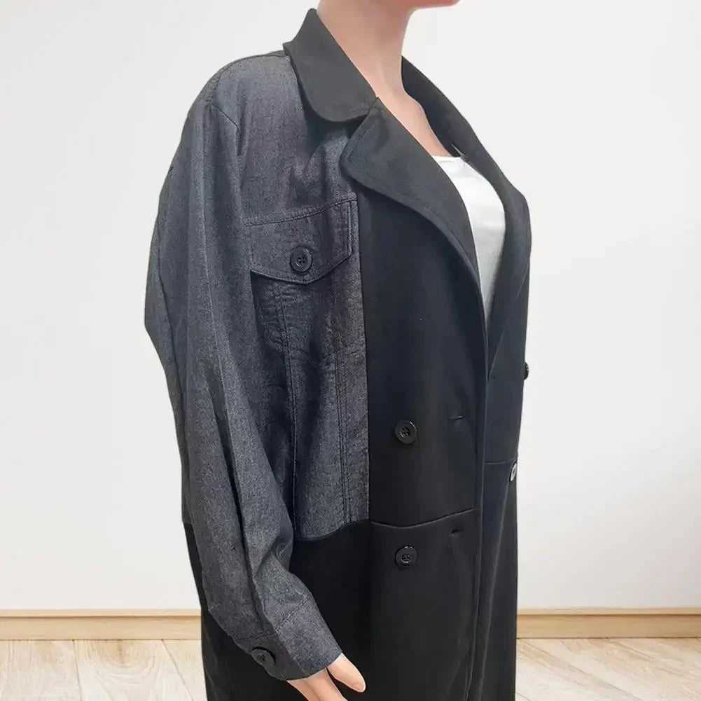 Woman wearing colorblock black and gray double-breasted coat with button details over white top