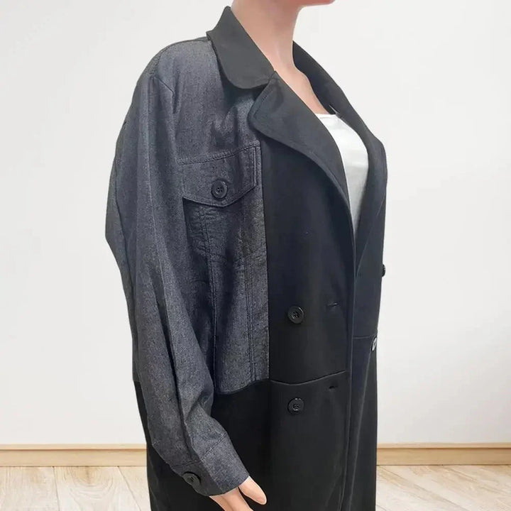 Woman wearing colorblock black and gray double-breasted coat with button details over white top