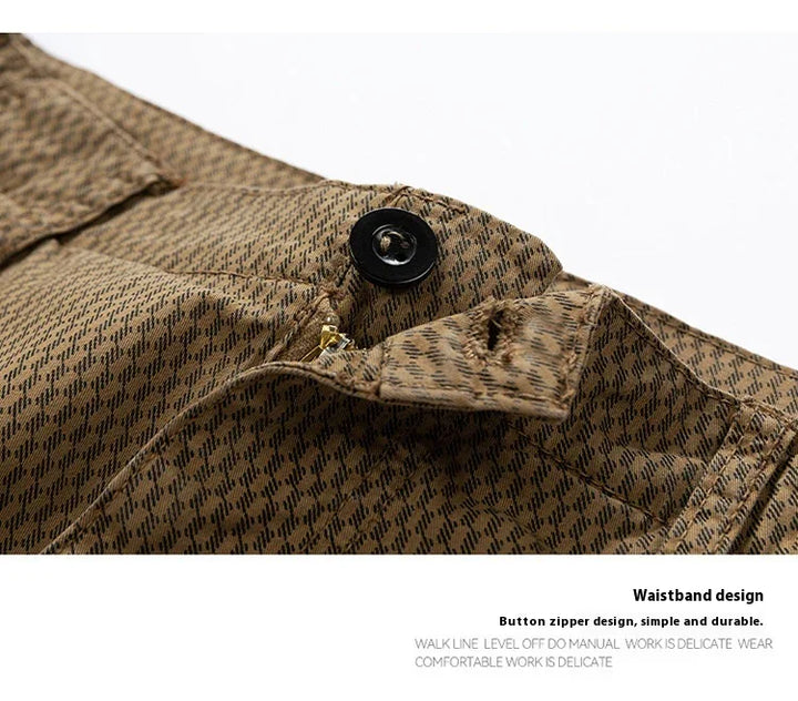 Close-up of brown patterned waistband with black button and brass zipper on pants