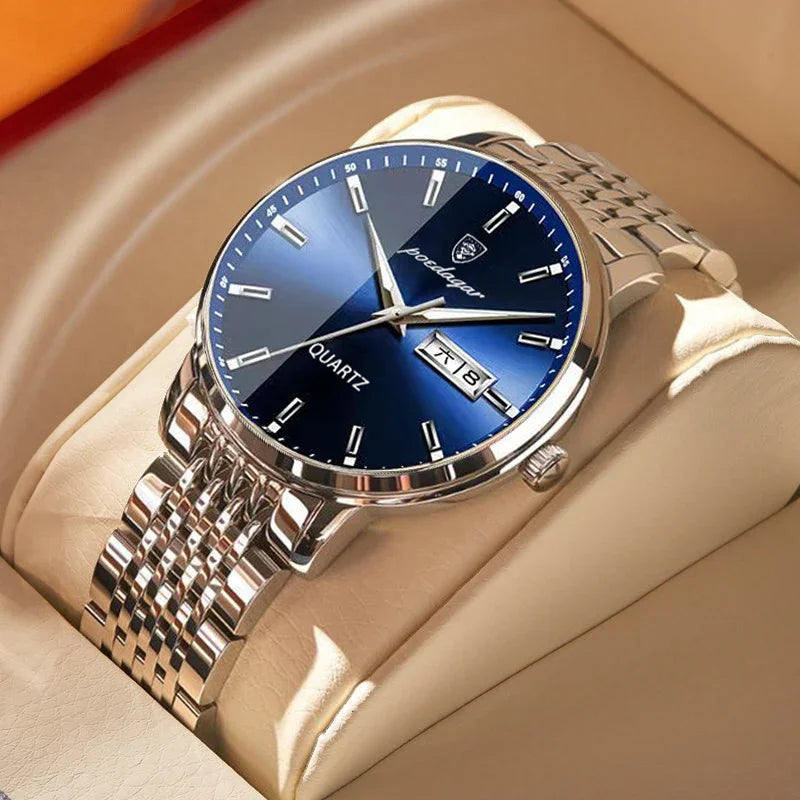 silver stainless steel quartz watch with blue dial and day date display on beige cushion