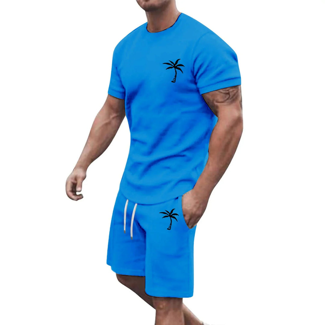 Muscular man wearing blue casual t-shirt and shorts set with black palm tree prints and white drawstrings