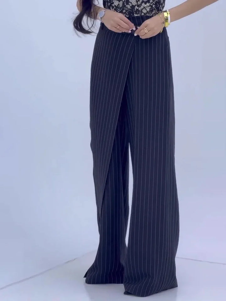 Woman wearing black pinstripe wide-leg pants with wrap overlay detail