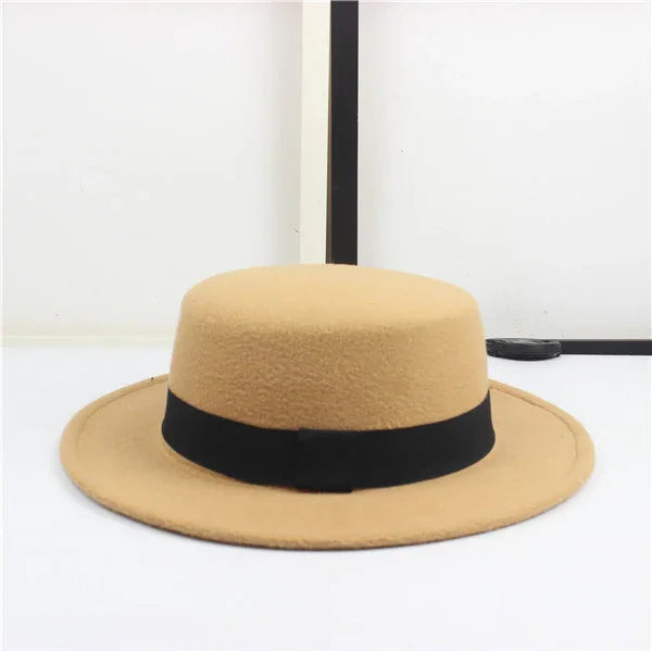 Beige felt wide-brim hat with black ribbon band on white background