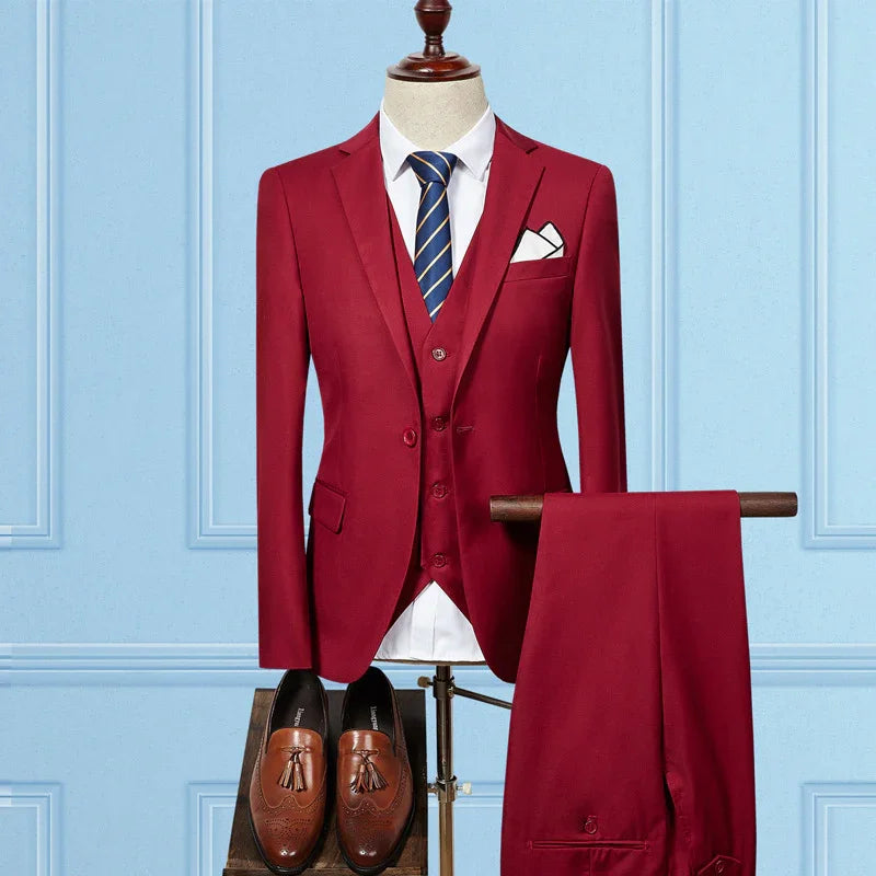 Red three-piece men's suit with white shirt, striped tie, brown tassel loafers, displayed on mannequin