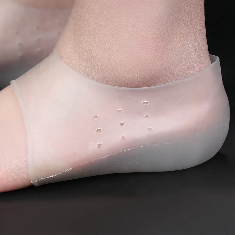 Silicone gel heel protector sleeve with ventilation holes on foot over black background