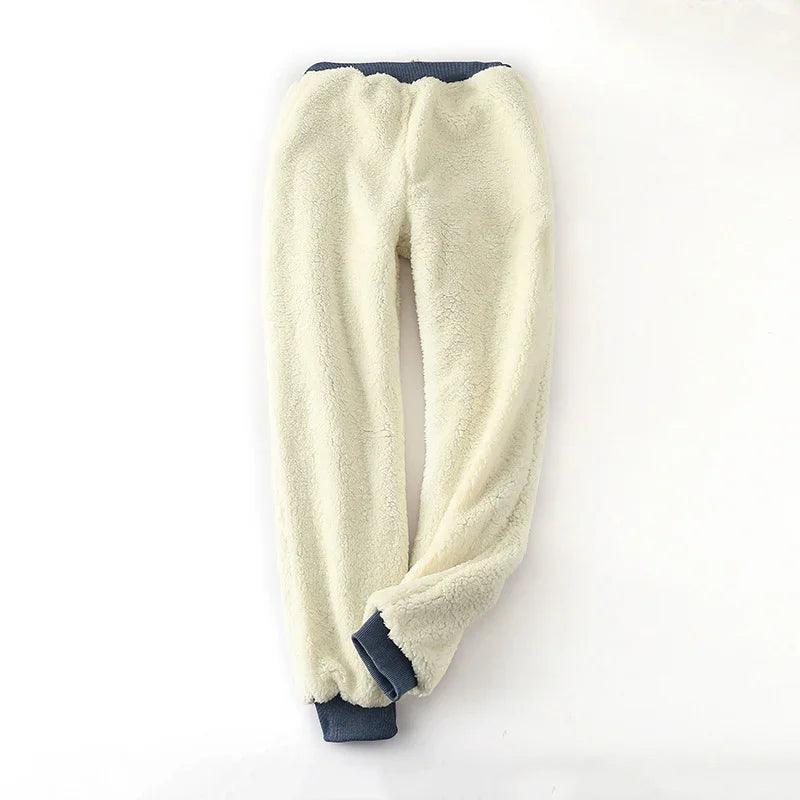 Cream sherpa fleece jogger pants with navy blue elastic waistband and cuffs on white background