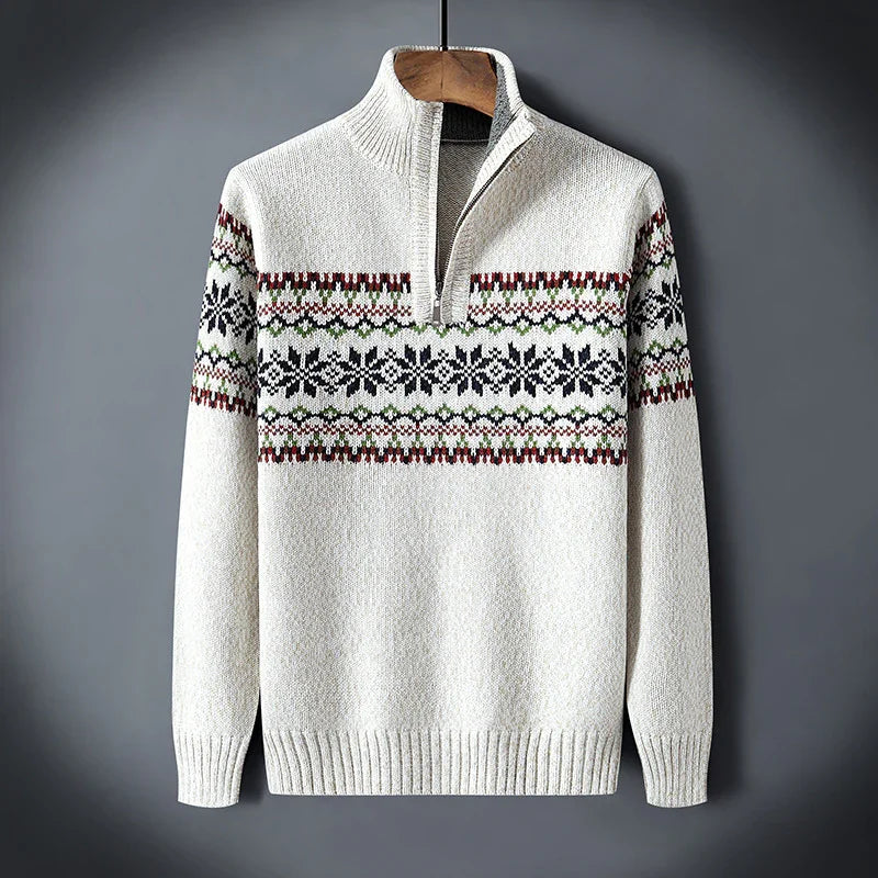 White knit sweater with half-zip and red, green, black patterned design across chest and sleeves