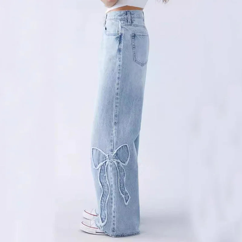 Light blue high-waisted wide-leg jeans with a bow embroidery on the lower leg