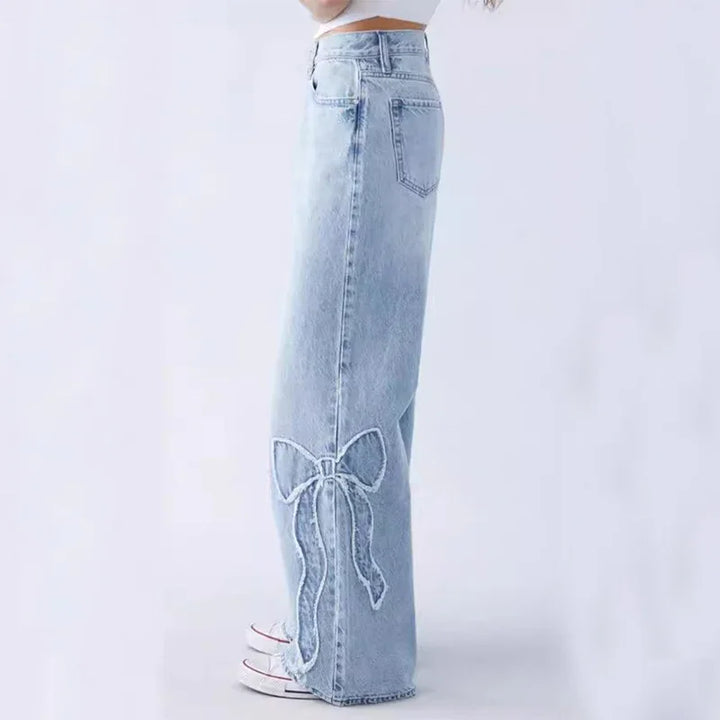 Light blue high-waisted wide-leg jeans with a bow embroidery on the lower leg