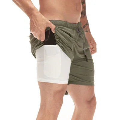 Man wearing olive green shorts with built-in white inner pocket holding a smartphone