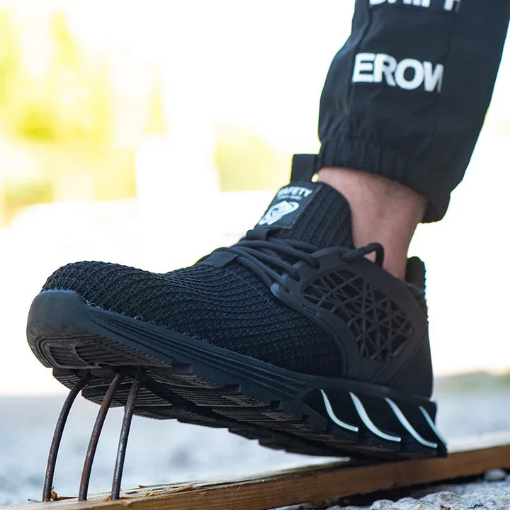 Black safety shoe with knit upper and durable sole stepping on exposed metal rebar outdoor