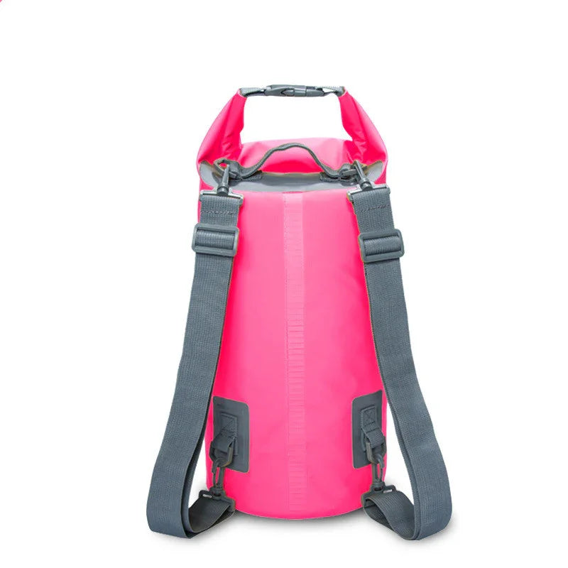 Pink waterproof dry bag backpack with black straps on white background