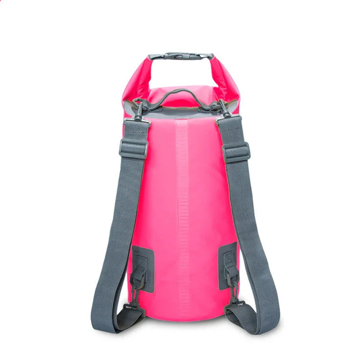 Pink waterproof dry bag backpack with black straps on white background