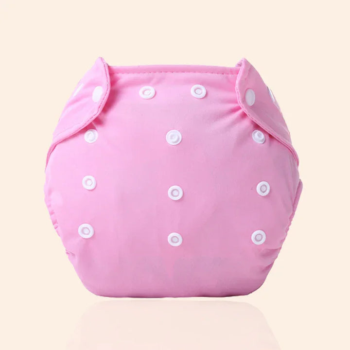 Pink reusable cloth diaper with adjustable white snap buttons for infants