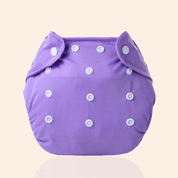 Purple adjustable cloth diaper with white snaps on beige background