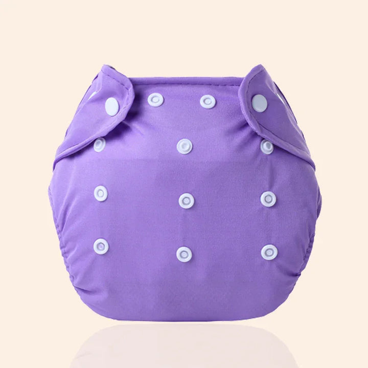 Purple adjustable cloth diaper with white snaps on beige background