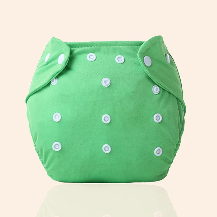 Green reusable cloth diaper with multiple white snap buttons on beige background