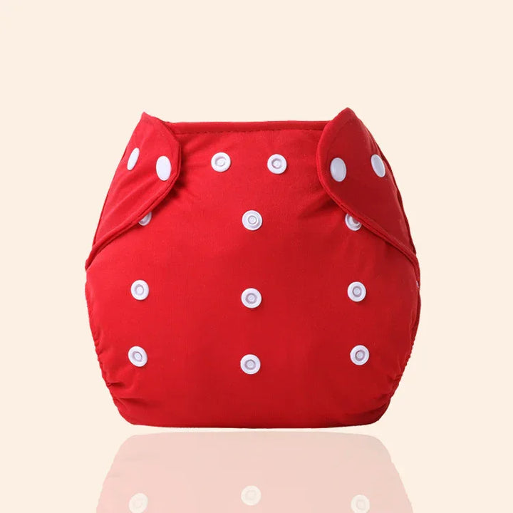 Red reusable cloth diaper with white snap buttons on beige background