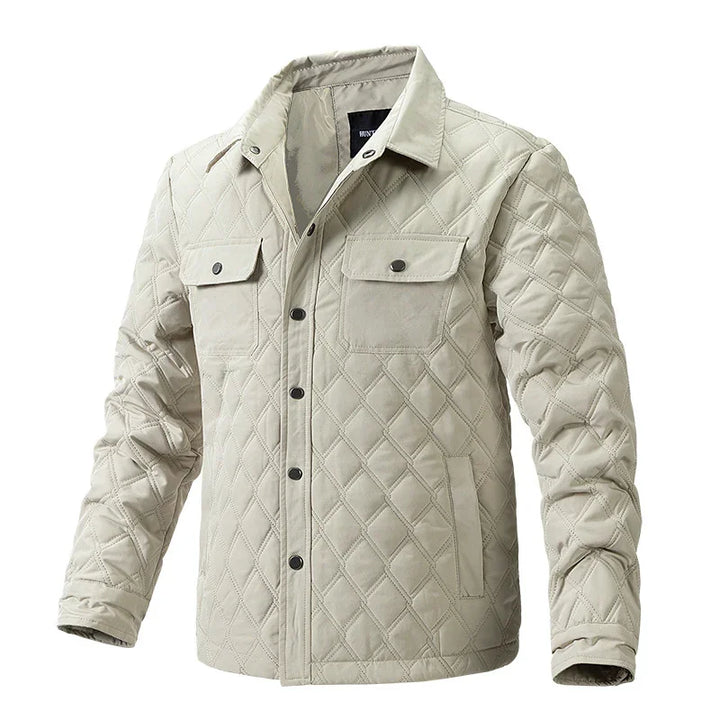 Beige quilted jacket with button closures and chest flap pockets on white background