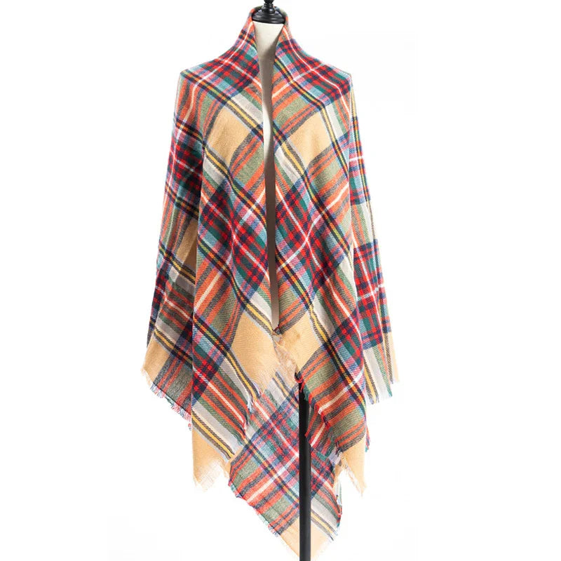 Plaid wool shawl in red, orange, blue, and beige draped on black mannequin