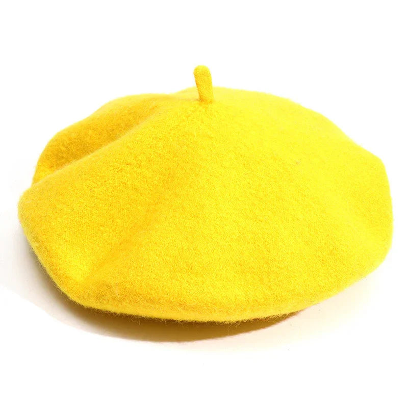 Bright yellow wool beret hat with classic round shape and top stem on white background